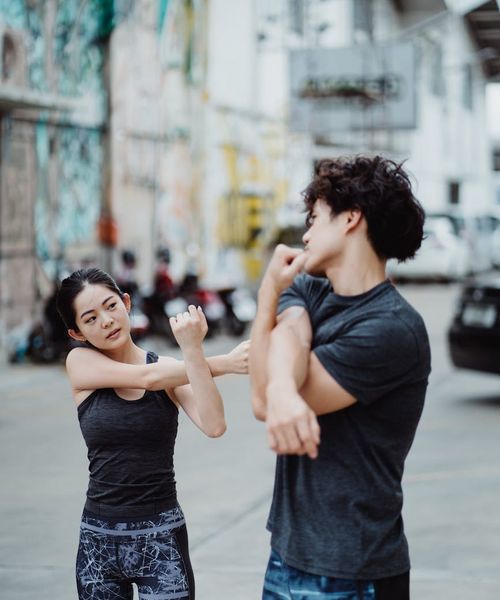 Person doing joint relaxation exercise outdoors